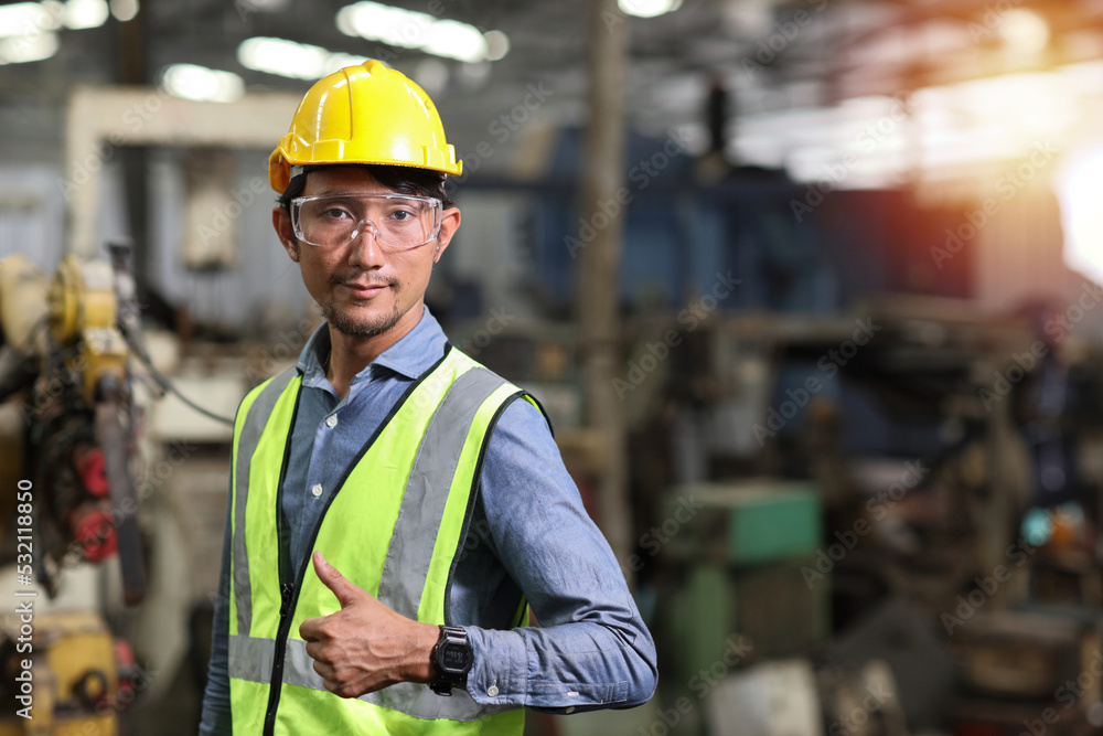 Technician engineer and worker in protective uniform standing with glasses and showing thumb up after controlling operation checking industry machine process at industry manufacturing Technician engineer and worker in protective uniform standing with glasses and showing thumb up after controlling operation checking industry machine process at industry manufacturing