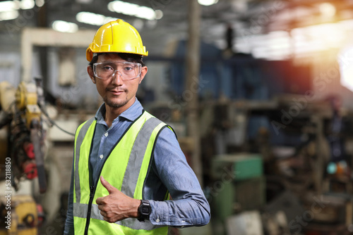 Technician engineer and worker in protective uniform standing with glasses and showing thumb up after controlling operation checking industry machine process at industry manufacturing