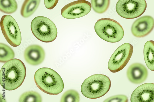 Levitation of sliced ripe kiwi on a green background, copy space.