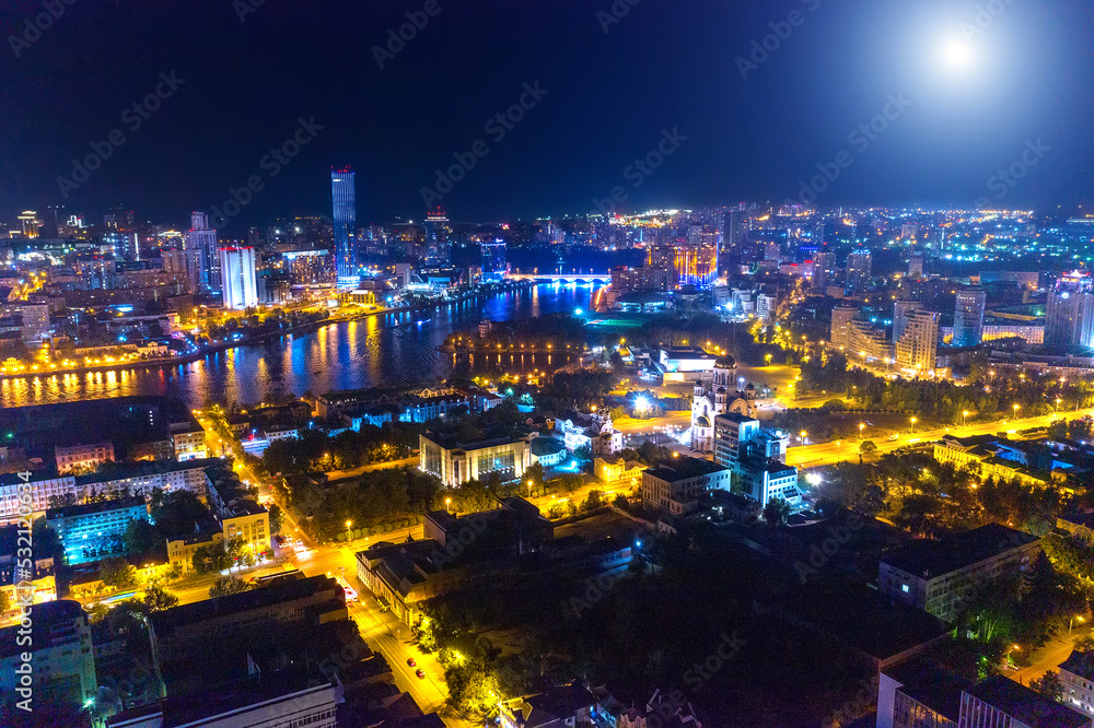 Aerial view of the night modern city. Bright moon and lights of the night streets Aerial view of the night modern city. Bright moon and lights of the night streets