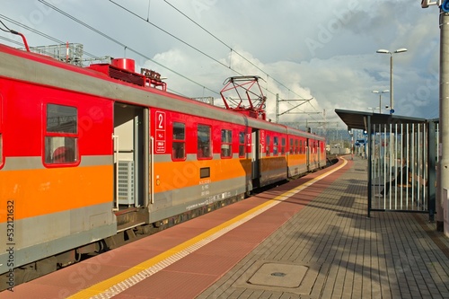 red old european charging train in the station