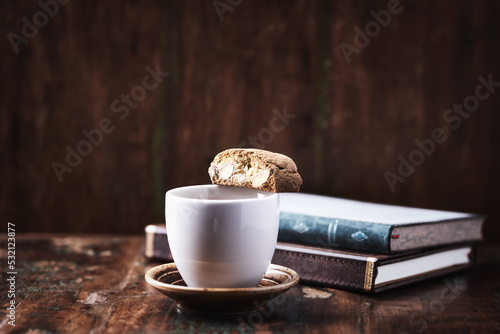 Cantuccini (Italian cookie) and a Cup of coffee on dark wooden background. Copy space 