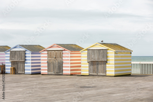 colourfull pier huts on hastings pier, copy space photo