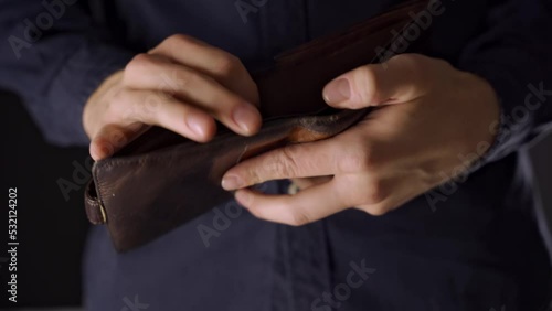 the man takes out his wallet. no money. empty wallet