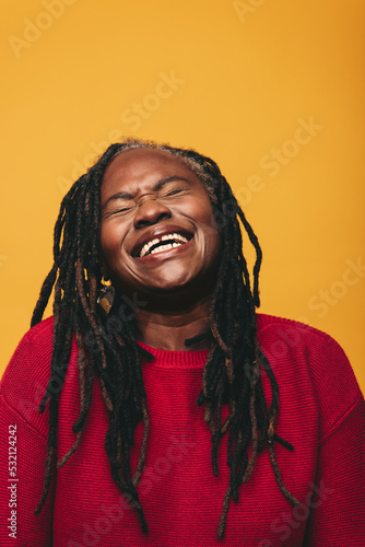 Happy black woman laughing cheerfully in a studio © Jacob Lund