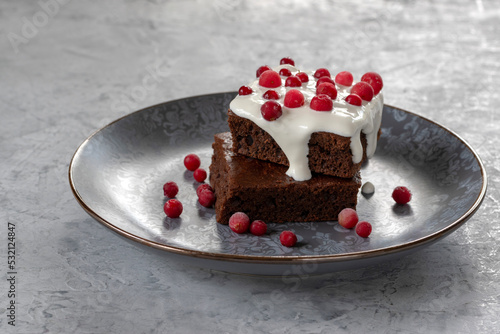 Brownie with sour cream and cranberries. Chocolate dessert.  Selective focus.