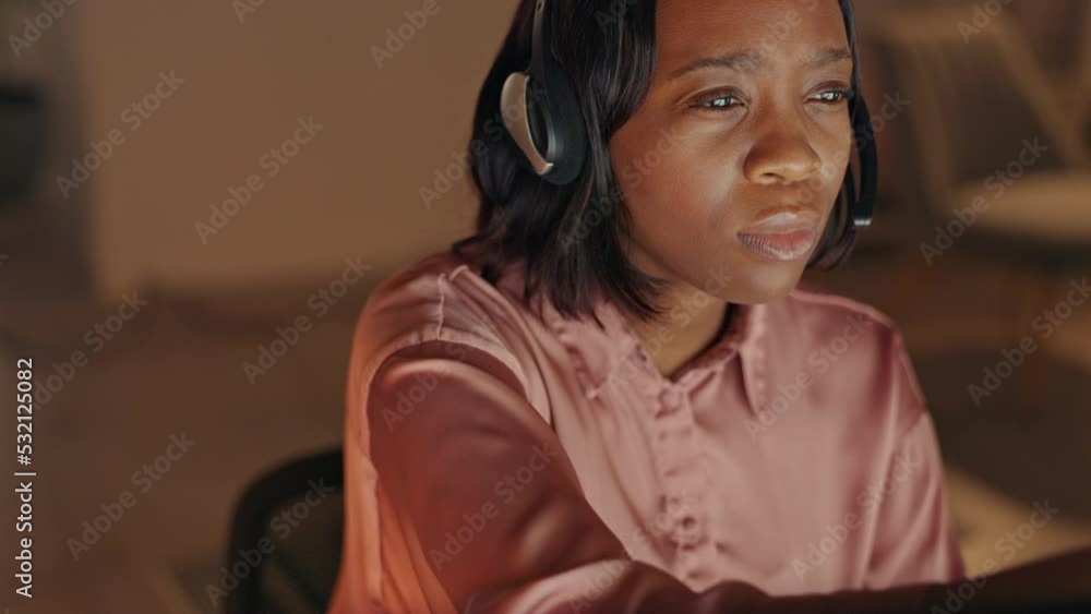 Thinking customer service, telemarketing or call center agent with headset working overtime at a helpdesk at night. Young woman online support worker focused and thoughtful working crm from home Thinking customer service, telemarketing or call center agent with headset working overtime at a helpdesk at night. Young woman online support worker focused and thoughtful working crm from home