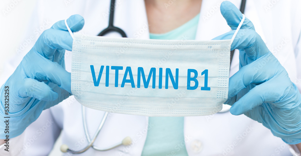 Vitamin B1 text on a face mask in the hands of a doctor, a medical concept Vitamin B1 text on a face mask in the hands of a doctor, a medical concept