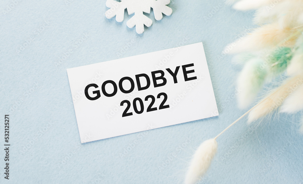 Goodbye 2022 text on a card on a blue background, business concept Goodbye 2022 text on a card on a blue background, business concept