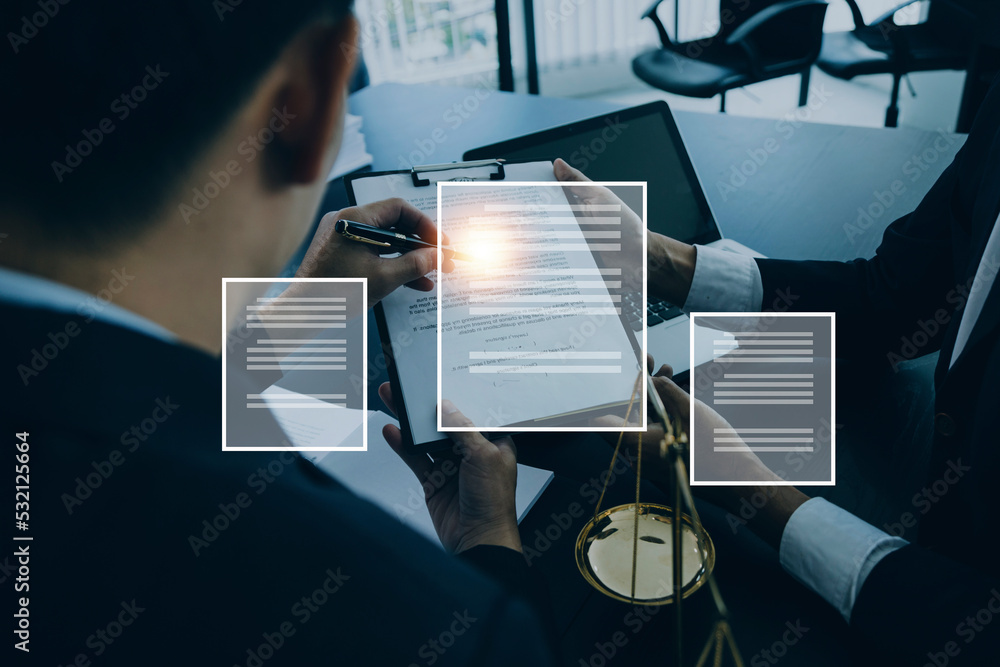 Naklejka premium Justice and law concept.Male judge in a courtroom with the gavel, working with, computer and docking keyboard, eyeglasses, on table in morning light