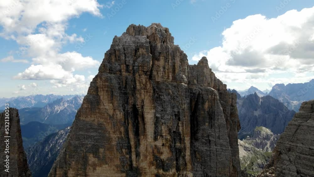 Aerial views of The Tre Cime di Lavaredo in The Italian Dolomites with a climber on the summit
