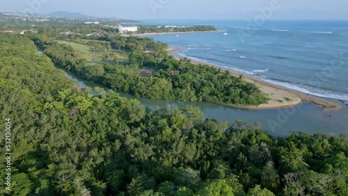 Rio Munoz River Mouth With Water Flowing Into The Atlantic Ocean In Puerto Plata, Dominican Republic. aerial drone photo