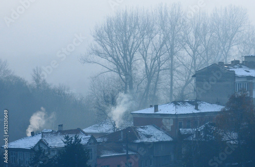 Foggy cityscape amd smoking chimneys