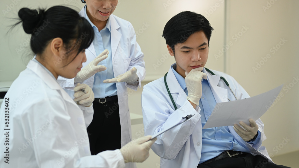 Professional scientists wearing white coats conducting experiment in research laboratory. Scientific research and technology concept Professional scientists wearing white coats conducting experiment in research laboratory. Scientific research and technology concept