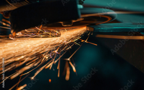 flying sparks from grinding metal, work with a manual grinder, closeup shot