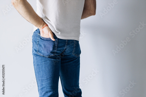 Beautiful male ass. Man stands with his back to camera. Buttocks men.