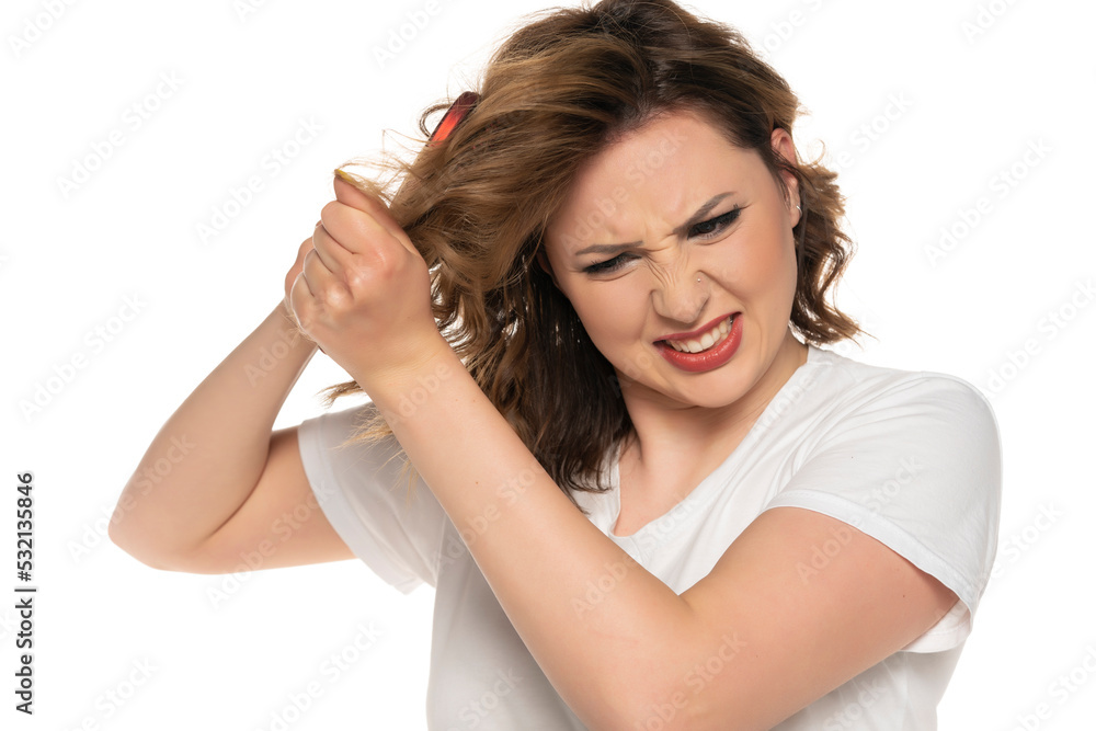 Woman with tangled hair and heir brush, isolated on white background. Woman with tangled hair and heir brush, isolated on white background.