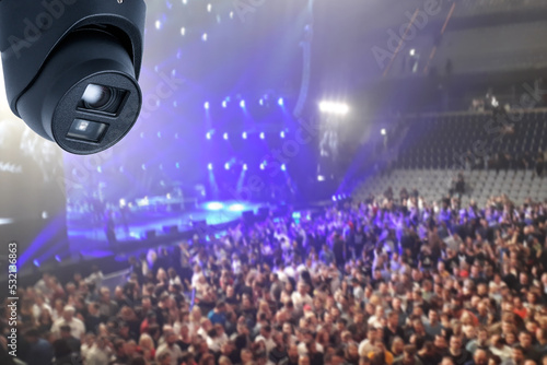 Surveillance Security Camera or CCTV with blurred concert background.