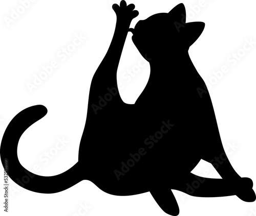 Isolated black silhouette of cat on white background. Flat cartoon cat licks paw.