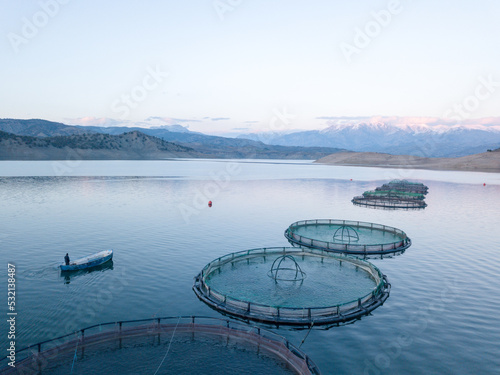 Aerial view of lake fish farm. Cages for fish farming dorado and seabass. 