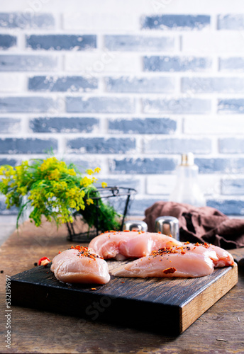 Raw chicken meat fillet on wooden background top view