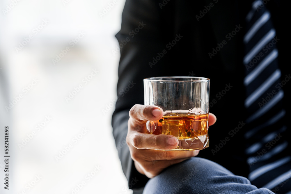 Sad depressed addicted drunk guy, Alone asian man drinker alcoholic sitting at bar counter with glass drinking whiskey. Sad depressed addicted drunk guy, Alone asian man drinker alcoholic sitting at bar counter with glass drinking whiskey.