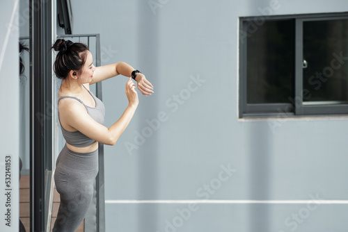 Woman Checking Fitness Tracker after Workout © DragonImages