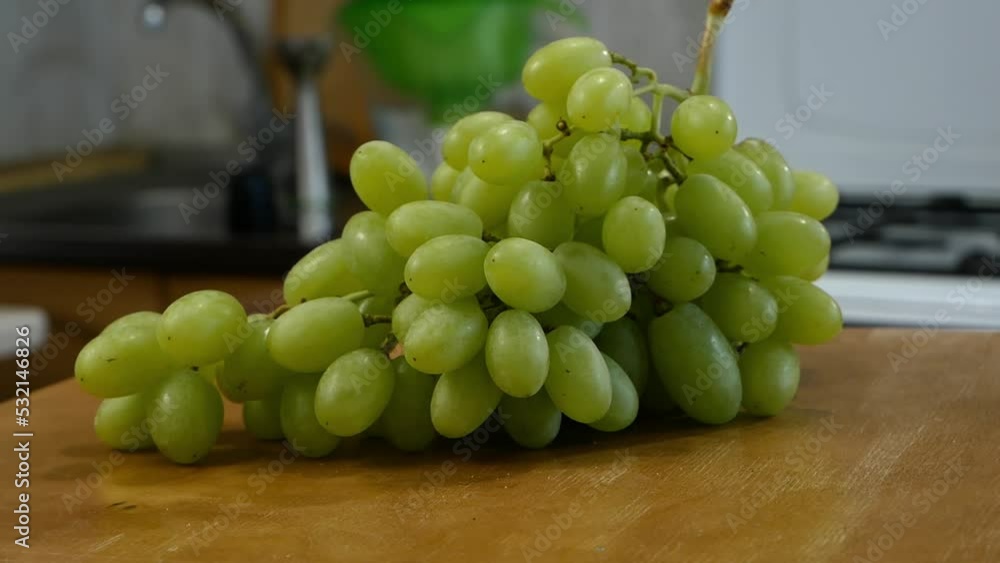 green grapes branch on wooden desk background moving around kitchen, parallax effect green grapes branch on wooden desk background moving around kitchen, parallax effect