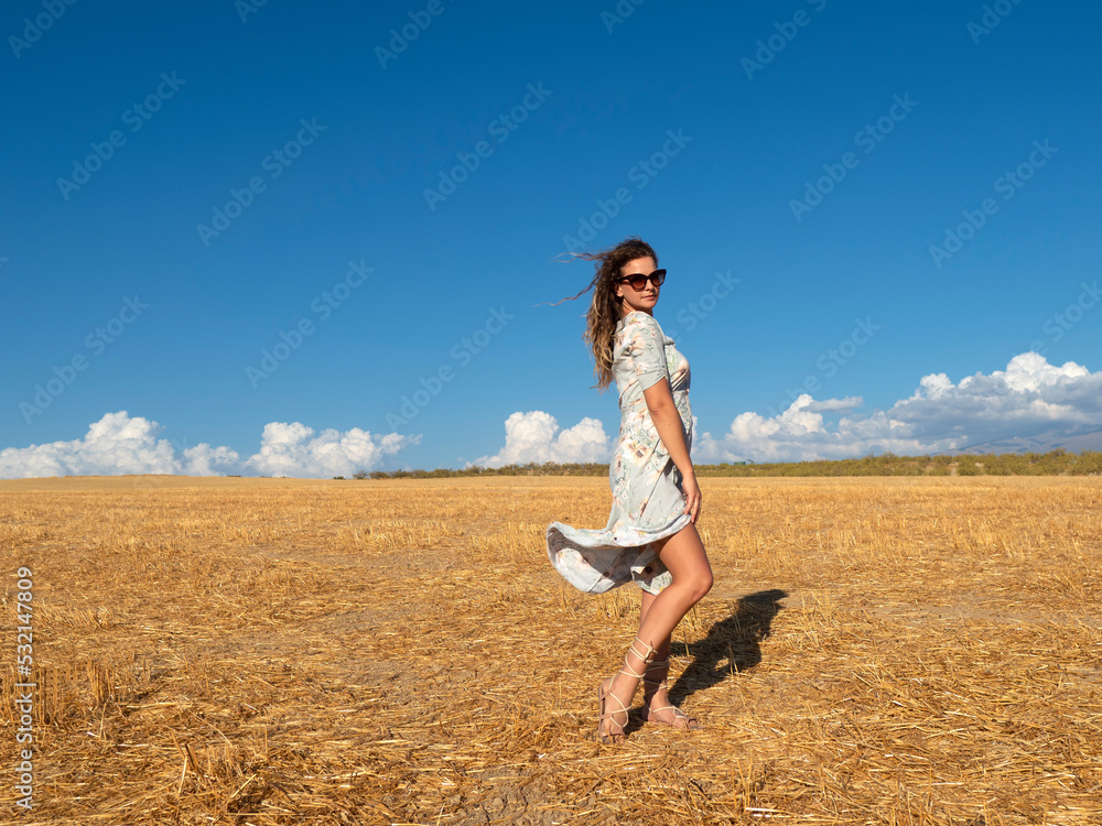 Romantic female in countryside field with blue sky Romantic female in countryside field with blue sky