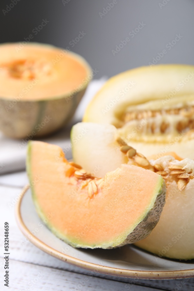 Tasty colorful ripe melons on white wooden table, closeup Tasty colorful ripe melons on white wooden table, closeup