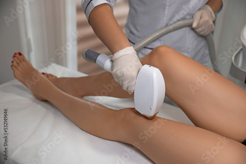 Woman undergoing laser epilation procedure in beauty salon, closeup