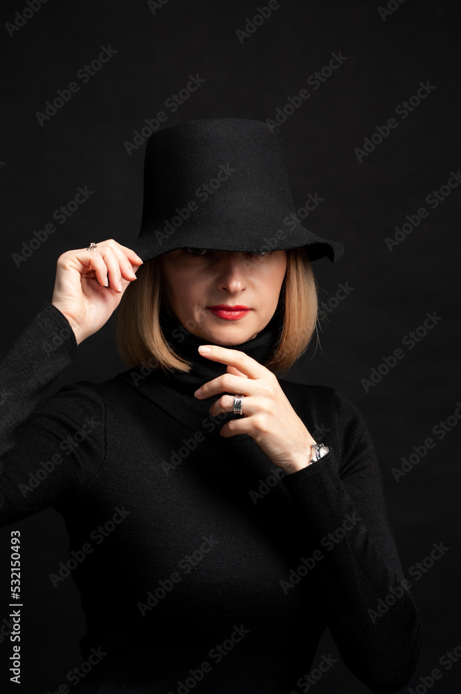 Woman in black dress and hat on background Woman in black dress and hat on background