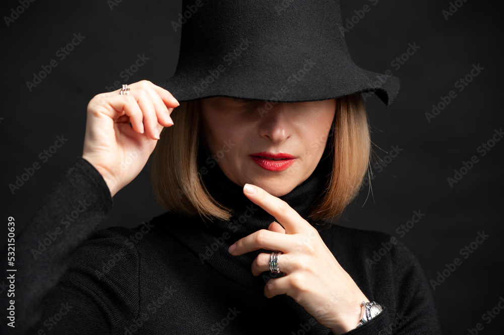Woman in black dress and hat on background Woman in black dress and hat on background