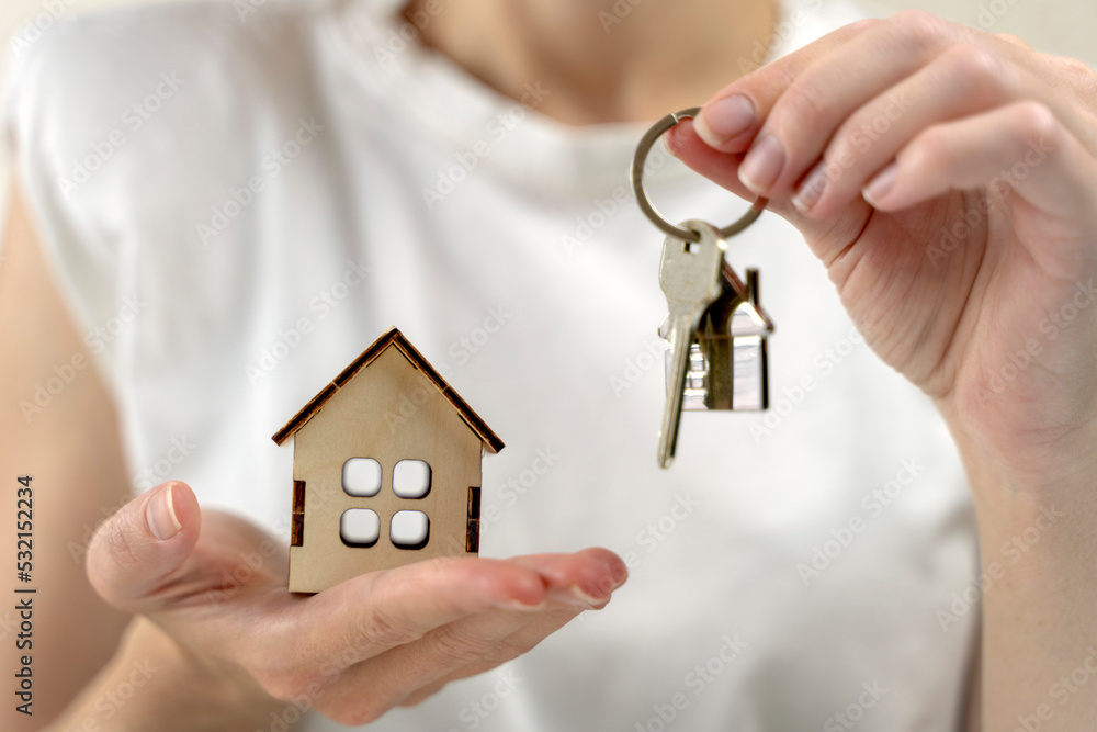 the key to your own home in the palm of the girl and a wooden house the key to your own home in the palm of the girl and a wooden house