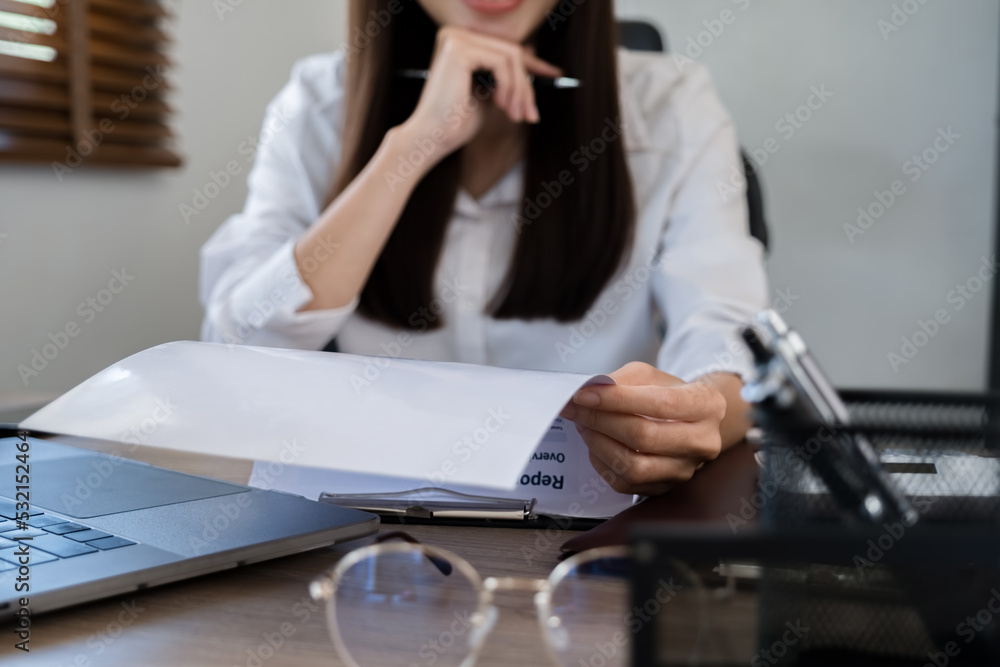 Marketer or analytic manager team dressed in suits working with paper charts and laptops at the meeting room. Marketer or analytic manager team dressed in suits working with paper charts and laptops at the meeting room.