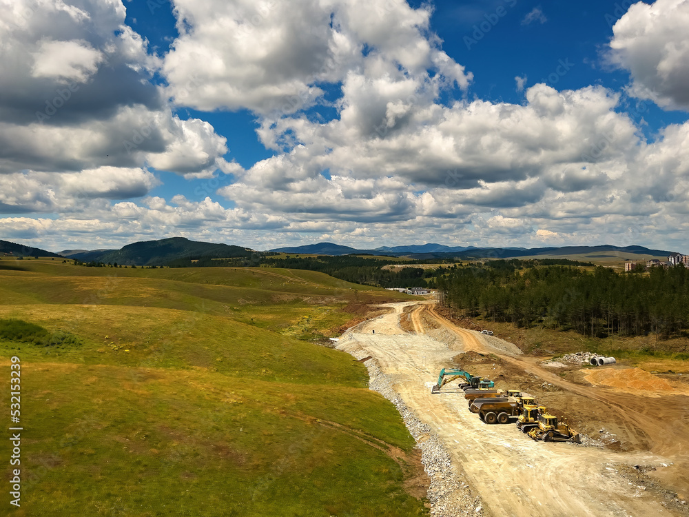 Road construction and heavy industrial machinery at Zlatibor, aerial view from drone pov Road construction and heavy industrial machinery at Zlatibor, aerial view from drone pov