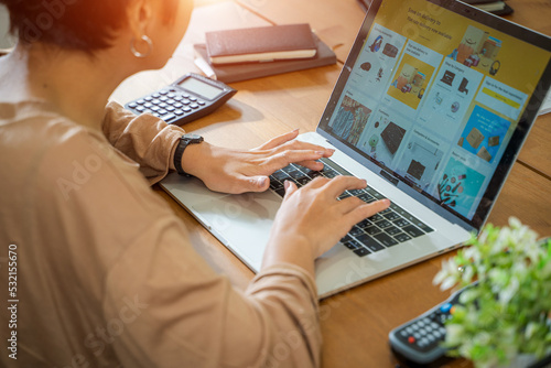 Woman shopping online via laptop computer,Using credit card for online shopping,Finance and debit,Lifestyle concept.