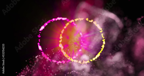 Images of moving yellow and pink glowing shapes over black background