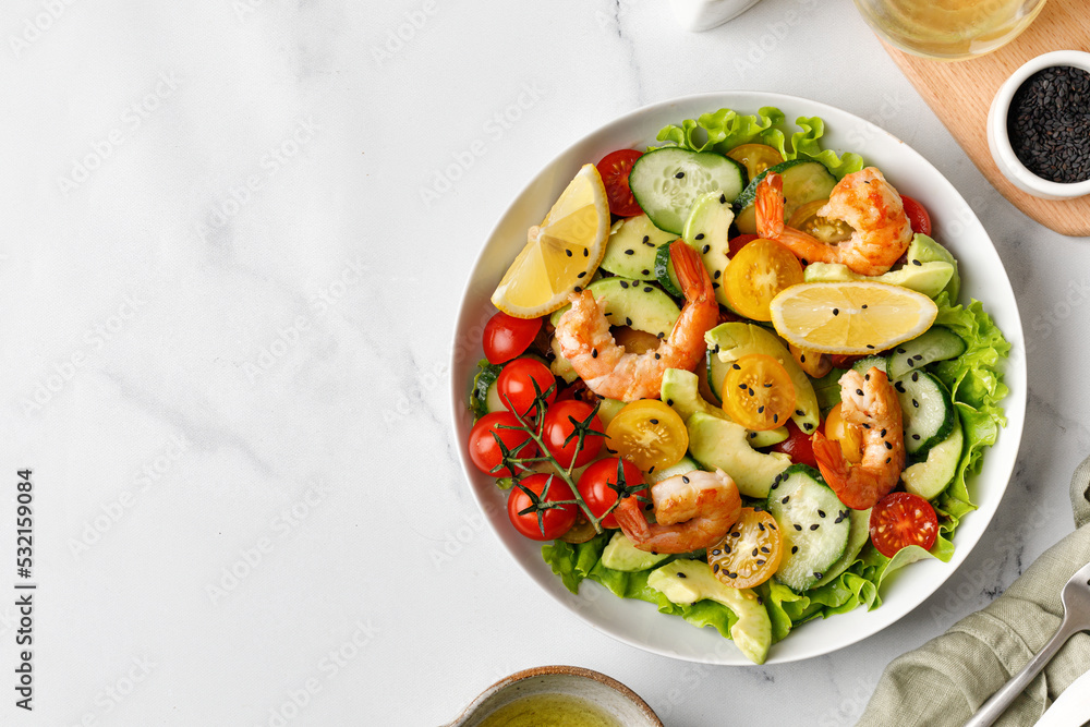 Fresh salad with shrimps, prawns, avocado and tomatoes. Shrimps salad with cucumber, avocado, green lettuce. Healthy diet seafood concept. Fresh salad with shrimps, prawns, avocado and tomatoes. Shrimps salad with cucumber, avocado, green lettuce. Healthy diet seafood concept.