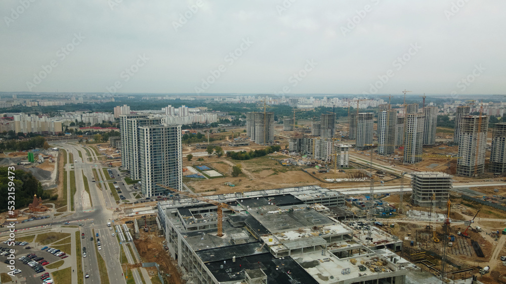 Obraz premium Construction site of a new city block. Construction of multi-storey buildings. Overcast weather. Aerial photography.