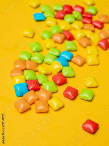 Obraz na płótnie Multicolored marmalade sweets on a yellow background.
w salonie
