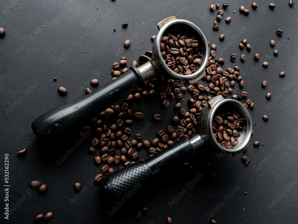 Coffee beans in a holder on a black background