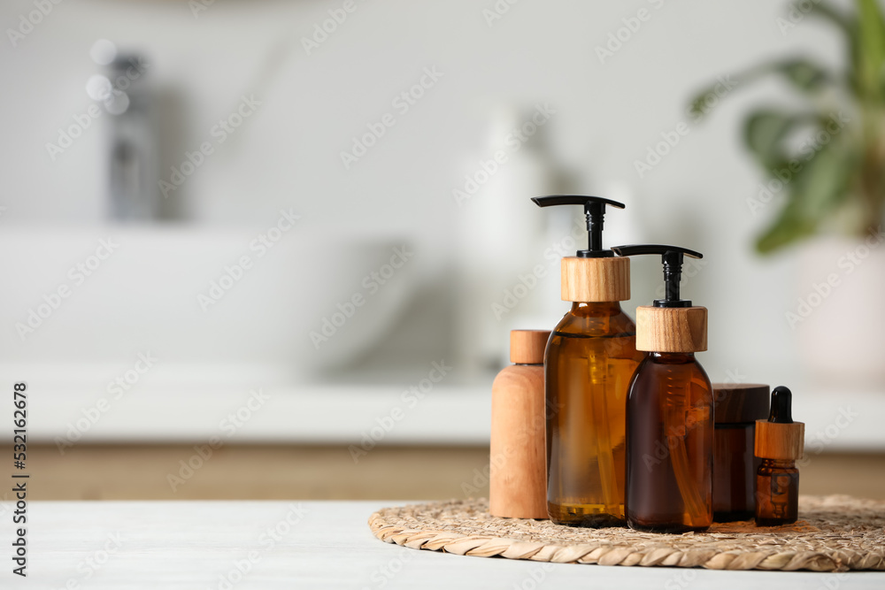 Different personal care products on white wooden table in bathroom. Space for text Different personal care products on white wooden table in bathroom. Space for text