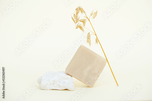 Trendy composition with otameal and honey soap bar made with natural ngredients and essential oils against light yellow background. Mockup image photo