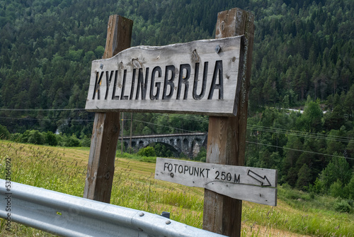 Overdalen, Norway - July 01, 2022: Kylling Bru is a railway bridge that is in hand-hewn stone. The Rauma line crosses the bridge in Verma, at the top of Romsdalen. Selective focus. photo