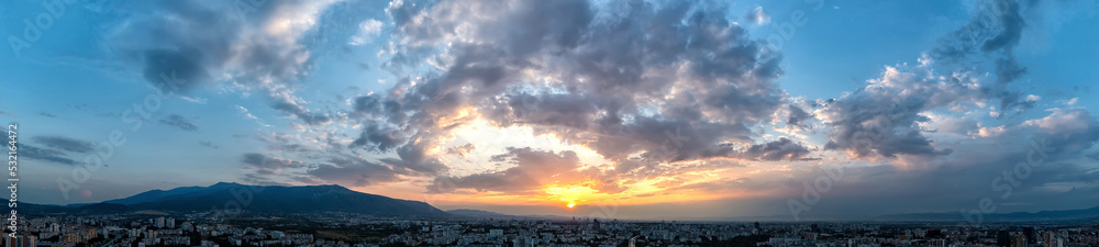Dramatic clouds and sun in the sky at sunset Dramatic clouds and sun in the sky at sunset
