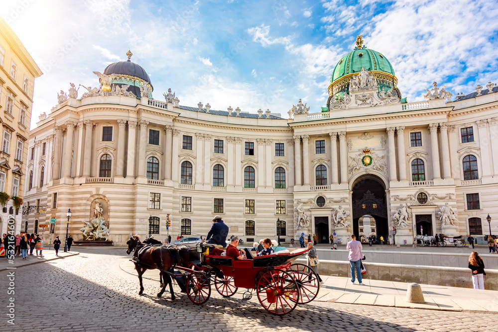 Naklejka premium Horse carriage at Hofburg palace on St. Michael square (Michaelerplatz), Vienna, Austria