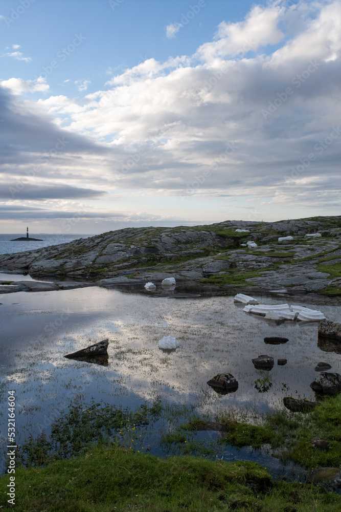 Wonderful landscapes in Norway. Vestland. Beautiful scenery of Columna Transatlantica on the Atlantic Road scenic route. Calm sea at the sunset in a cloudy day. Sunrays through clouds. Selective focus