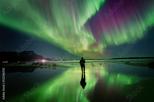 Aurora's reflection and the woman on the beach photo