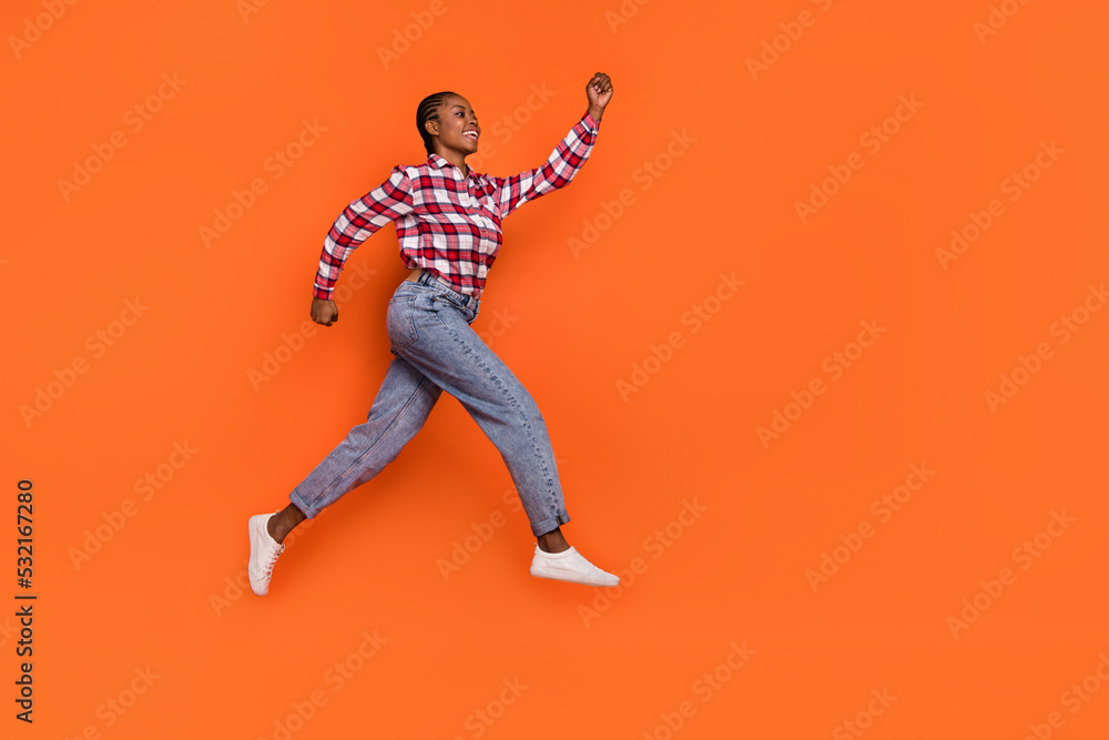 Full body photo of energetic sportive lady hurry rush fast look empty space isolated on orange color background